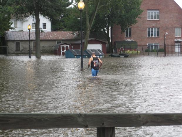 submitted-by-tiffany-feldman-from-westampton-nj-this-is-mt-holly-nj-a-resident-walks-back-to-his-house-after-driving-his-car-out-of-the-flooded-parking-lot.jpg 