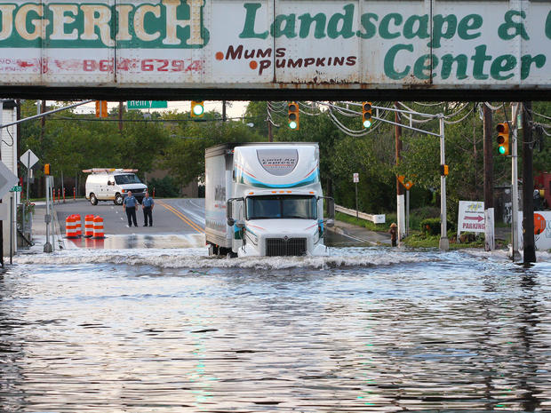 A tractor trailer drives through the flood water that goes up and over his headlights on Secaucus Road in Secaucus, N.J. after Hurricane Irene caused major flooding. 