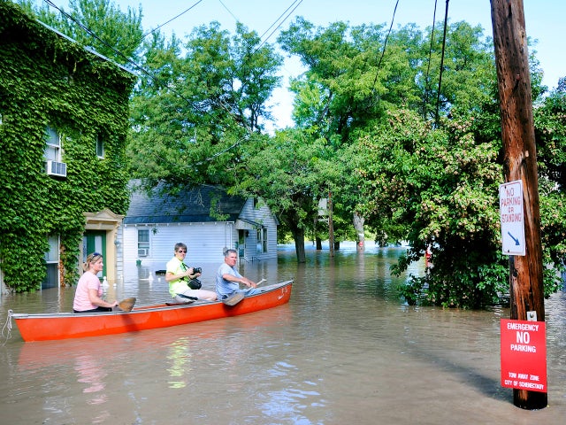 Susan Duggan-Cooley of Schenedtady, left, and Claire and Brian Houlihan of Scotia, take a kayak out on North Street in the historic Stockade section of Schenectady, N.Y. 