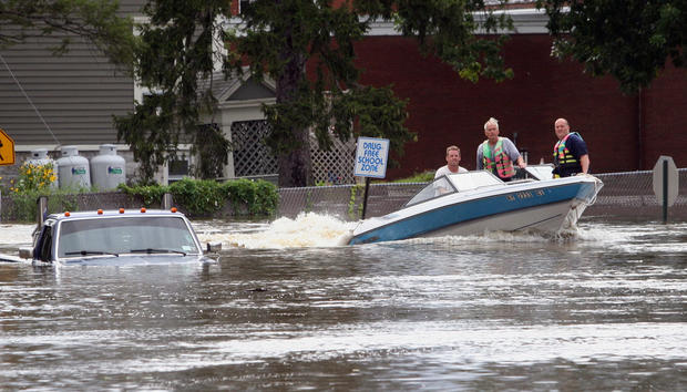 A motorboat passes a submerged pickup truck on Main St. in Washingtonville, N.Y., Aug. 28, 2011 following heavy rains from Irene. 