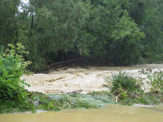 A historic footbridge is washed away by flood waters from Topical Storm Irene at Mt. Anthony Country club in Bennington, Vt.,  Aug. 28, 2011. 