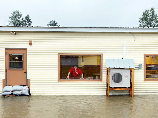 Jimmy Rossi, owner of Canaan Village Pizza, looks out the window as water from Mascoma River rises around his restaurant in Canaan, N.H.,  Aug. 28, 2011 