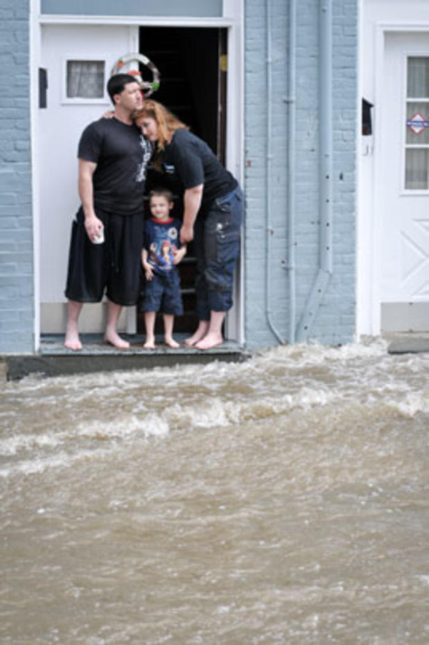 Residents watch as floodwaters from Hurricane Irene stream down Vineyard Avenue in Highland, N.Y., Aug. 28, 2011. 