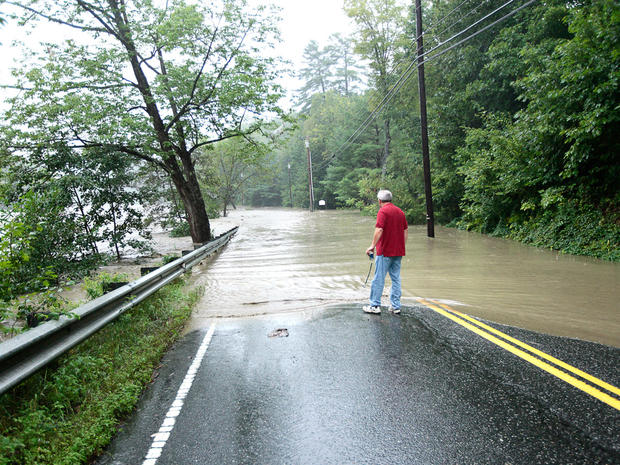 Kevin Tole looks out over Quechee Main Street in Lebanon, N.H., as is floods with water from the Ottauquechee River on Aug. 28, 2011.  