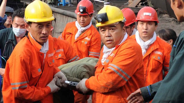 Rescuers carry a miner out of a flooded mine in northeast China 