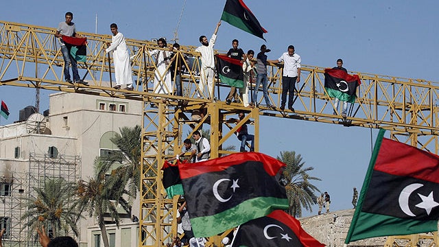 Libyans wave flags in Green Square, renamed Martyr's Square, for the morning Eid prayer, marking the end of Ramadan and to celebrate their victory over embattled Muammar Qaddafi, inTripoli, Libya, Aug. 31, 2011.  