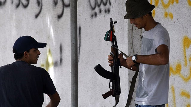 Libyan rebels stand at a checkpoint in Tripoli, Libya, Sept. 1, 2011.  