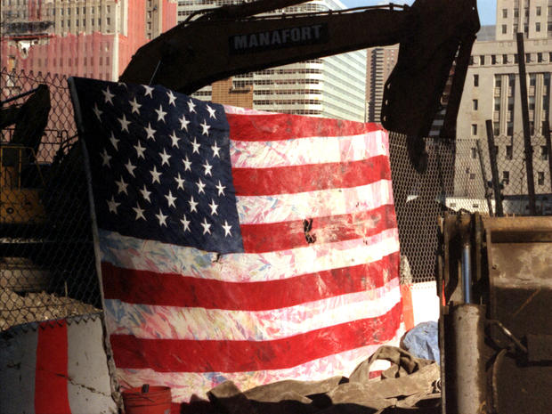 A U.S. flag found by workers sifting through the rubble at ground zero hangs out to dry so that it can be saved Feb. 14, 2002, in New York City. The colors have run into the white from being buried in damp soil for five months. 
