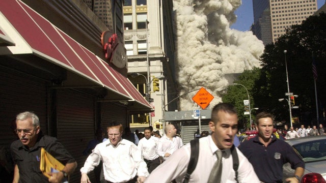 People run from a cloud of debris 