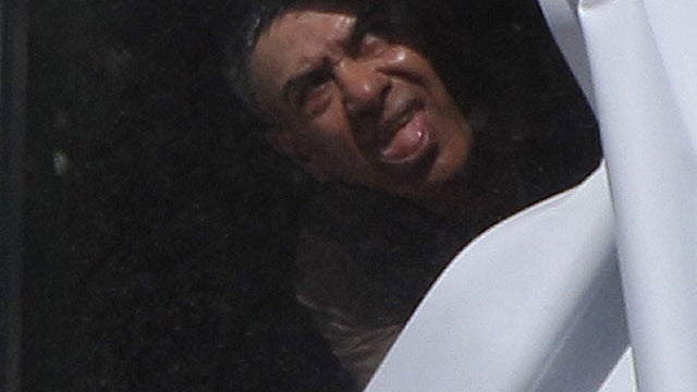 A man believed to be holding a child hostage at a lawyers office looks out a window in suburban Sydney, Sept. 6, 2011.  