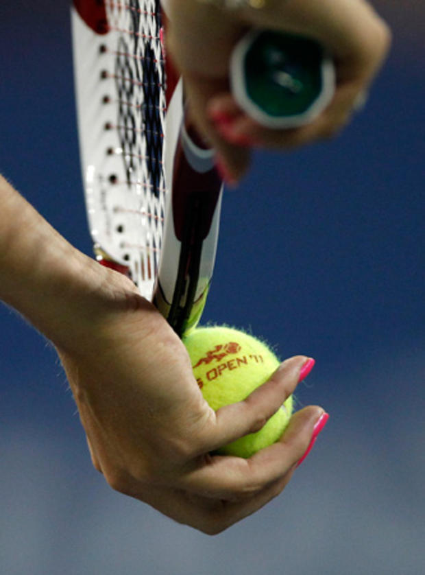 Caroline Wozniacki grips the tennis ball  