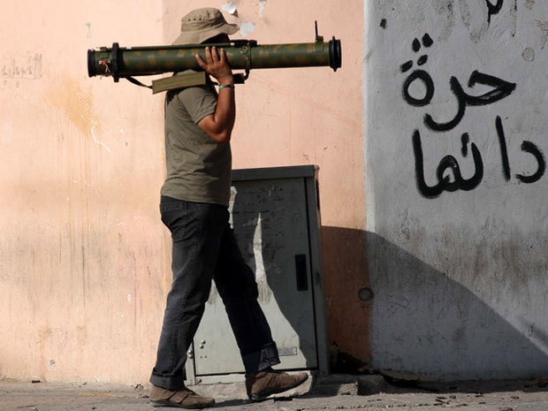 A Libyan rebel holds a portable rocket launcher near the main square of Zawiya, Libya, Aug. 18, 2011. 