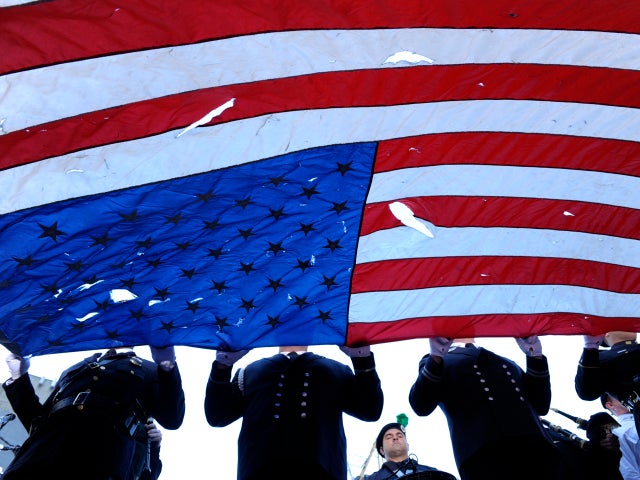 An honor guard carries a flag found at ground zero at the beginning of the annual 9/11 memorial service Sept. 11, 2010, in New York City. 