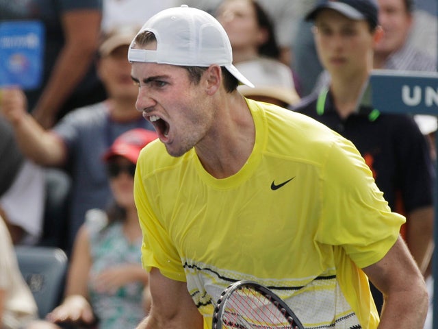 John Isner reacts after winning  