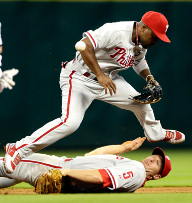 Jimmy Rollins, top, tries to avoid stepping on second baseman Pete Orr  