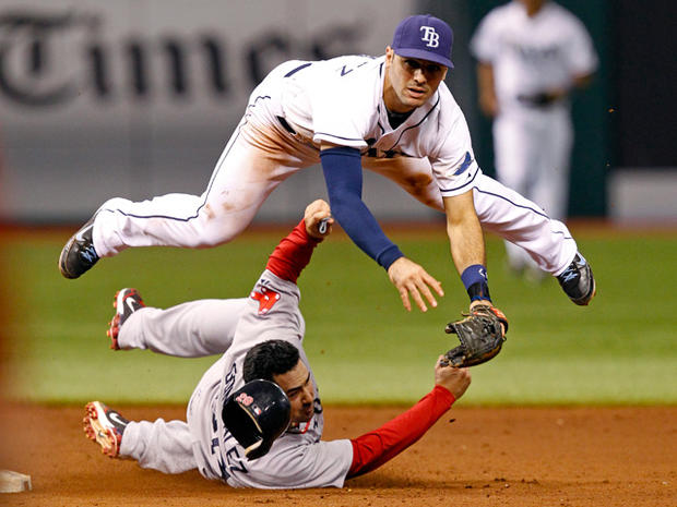 Adrian Gonzalez slides into second base in an attempt to break up a double-play 