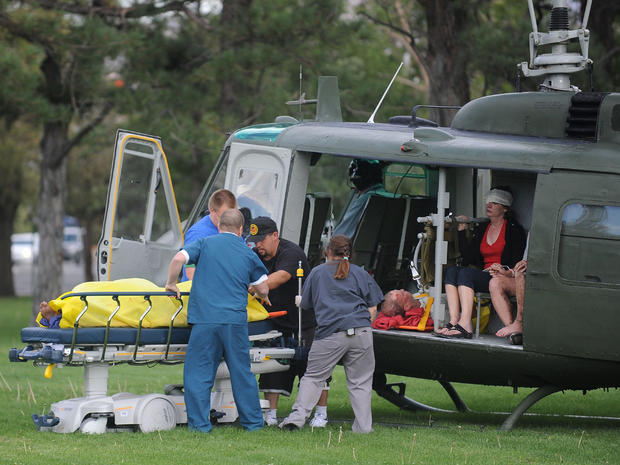 Medics help injured bystanders out of a helicopter into Renown Medical Center after a plane crashed into the crowd at the Reno National Championship Air Races 
