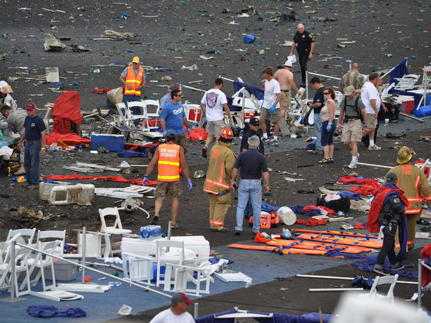 A crowd gathers around debris after a P-51 Mustang airplane crased at the Reno Air show on Friday, Sept. 16, 2011 in Reno Nev.. 