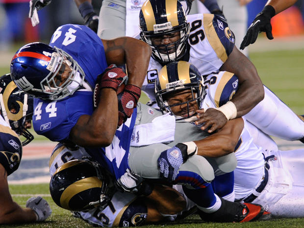 Ahmad Bradshaw  is tackled by defenders 