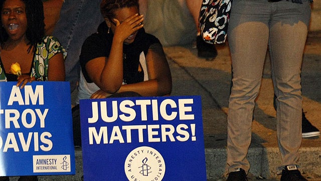 Protesters react as they hear that Troy Davis had filed an eleventh-hour plea asking the U.S. Supreme Court to stop Georgia authorities from executing him for the murder of an off-duty police officer, Sept. 21, 2011 in Atlanta. 