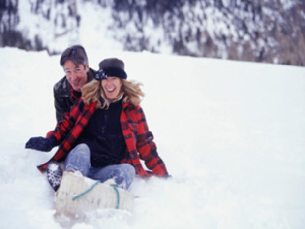 12/23/11 - A Guide To Twin Cities' Sledding Hills – man and woman sledding 