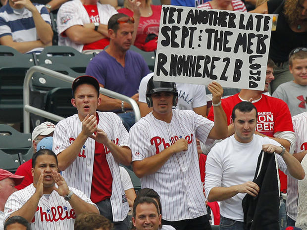 Philadelphia Phillies fans hold a sign   