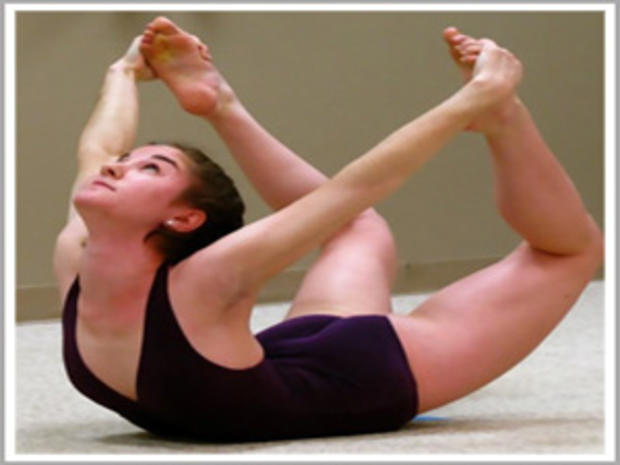 12/31/11- Best Ways to Stay Fit During the Winter- Woman in black doing yoga 