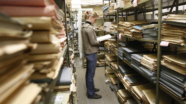 An archivist Melanie Wehr reads in the depot of the Federal Archive in Ludwigsburg, Germany. 