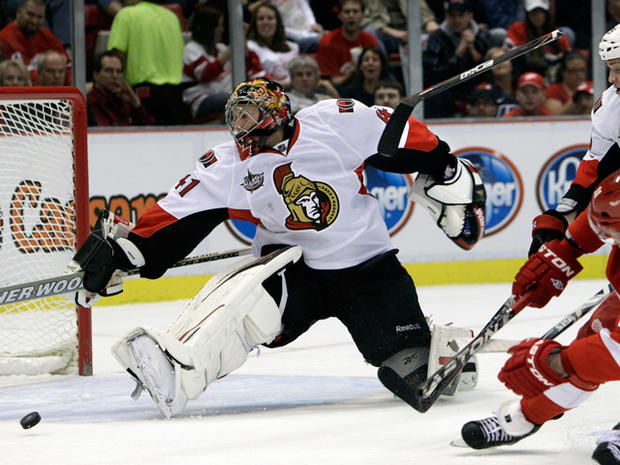 Craig Anderson stretches to deflect a shot  