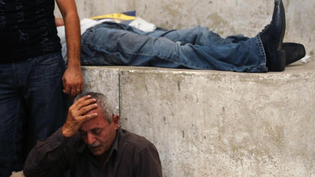 A man grieves near the bodies of Egyptian protesters  