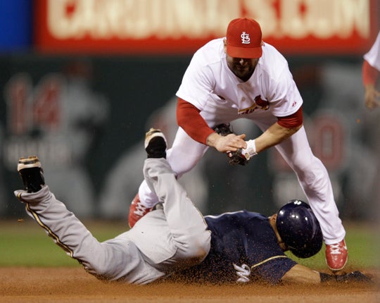 Carlos Gomez is tagged out by Nick Punto  