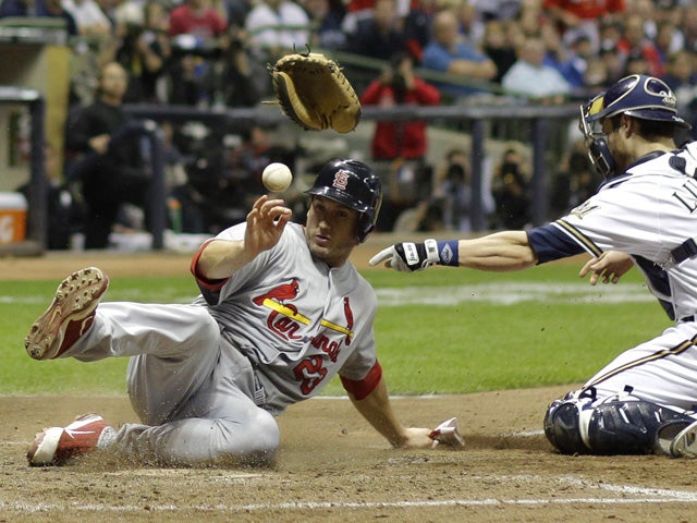 David Freese knocks the glove and ball away from Jonathan Lucroy 