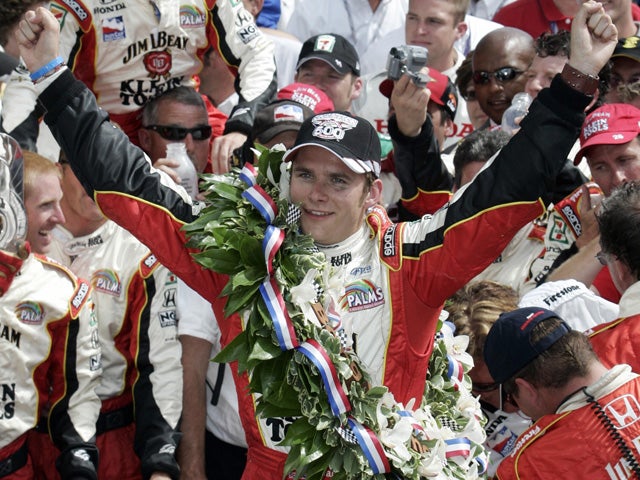 Dan Wheldon celebrates in the winners circle 