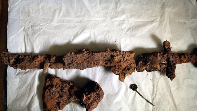 A Viking sword, axe head and bronze ring pin are seen on display at CFA Archaeology Oct. 18, 2011, in Edinburgh, Scotland, after being discovered in the first intact Viking boat burial site of its kind. The grave uncovered on the Ardnamurchan peninsula co 
