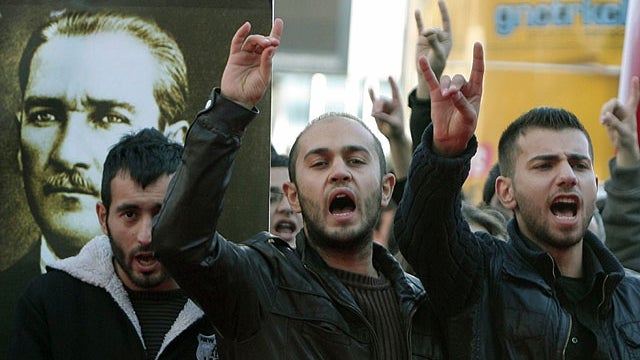 A group of angry Turks protest the killings of 24 Turkish soldiers, in front of a portrait of Turkey's founder Kemal Ataturk, outside the office of the prime minister in Ankara, Turkey, Oct. 19, 2011.  
