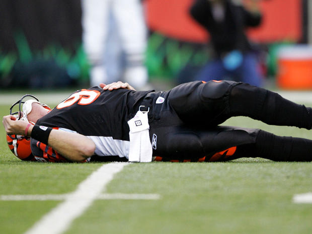 Carson Palmer lays on the ground after being hit in the knee 