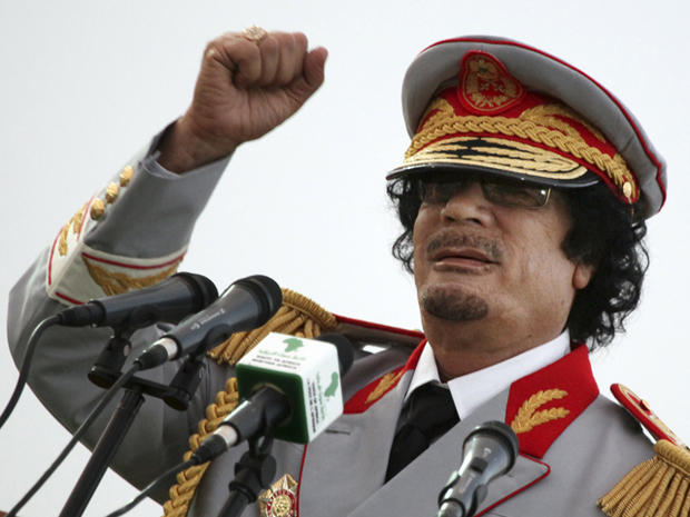 Moammar Qaddafi talks during a ceremony 