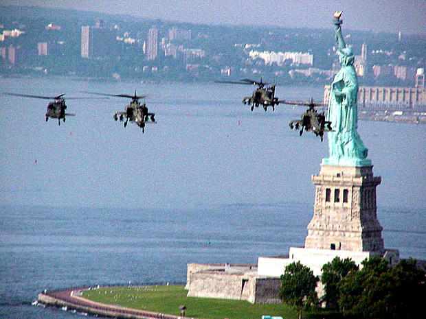 Apache helicopters fly past the Statue of Liberty Aug. 4, 1999, before being loaded on a cargo ship in Staten Island, N.Y., and sent to Bosnia. The "Flying Tigers" battalion is one of only two Apache battalions in the Army Reserve and was sent to Bosnia t 