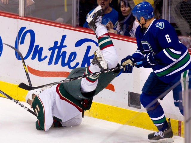 Kyle Brodziak is upended Sami Salo 