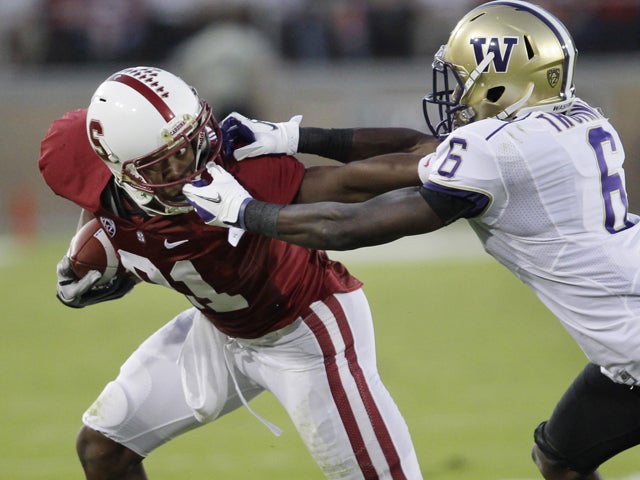 Desmond Trufant grabs the face mask of Chris Owusu 