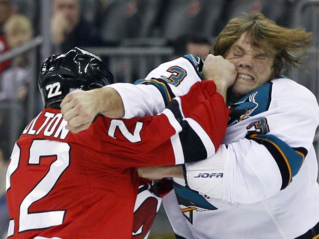 Eric Boulton knocks off his skates as they fight 