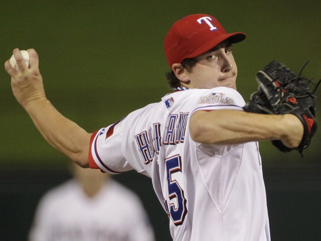 Derek Holland throws during the first inning 