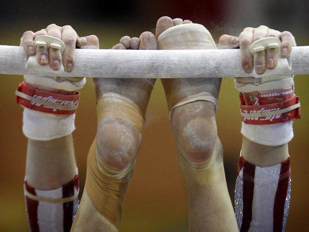 Elizabeth Sloan competes in the uneven bars 