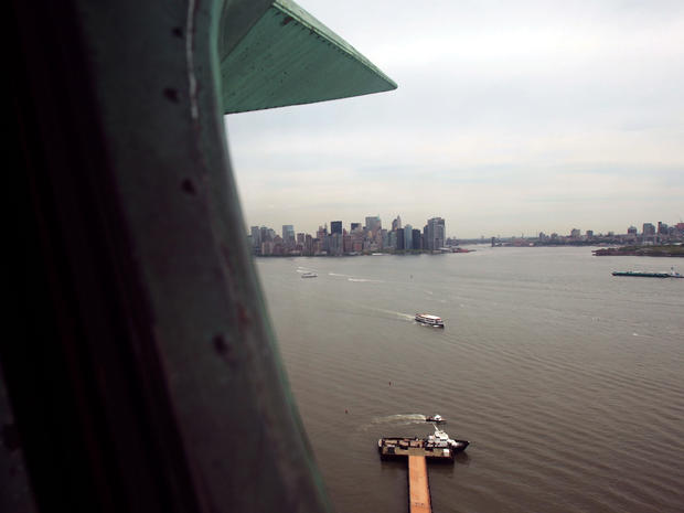 Lower Manhattan is seen through a window in the crown of the Statue of Liberty May 8, 2009, the day Secretary of the Interior Ken Salazar announced that the crown, closed to the public after the 9/11 attacks, would open again that Fourth of July to a limi 