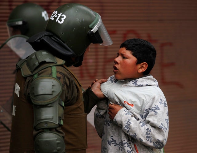 A police officer confronts a youth 