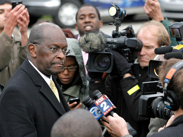 DETROIT, MI - OCTOBER 21: Republican presidential candidate Herman Cain speaks with the news media after unveiling his 'Opportunity Zone' economic plan in front of the Michigan Central Station, an abandoned train depot, October 21, 2011 in Detroit, Michigan. Cain has reportedly proposed changes to his '9-9-9' tax plan to exempt taxes for those living at or below the poverty line and businesses investing in 'Opportunity Zones' 