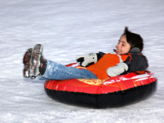 1/7/12 – Travel &amp; Outdoors – Best Places to Play in the Snow – little boy in snow tube 