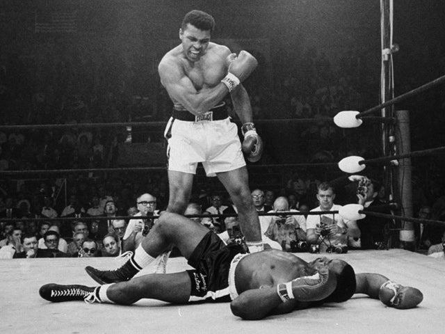 Muhammad Ali stands over Sonny Liston 