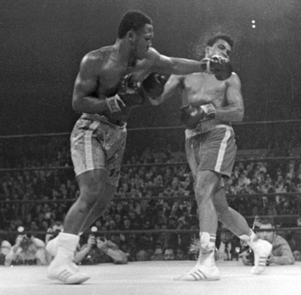Muhammad Ali takes a left from Joe Frazier  