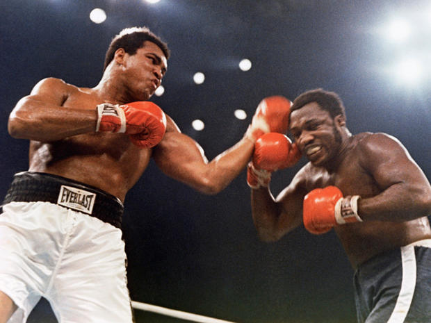 Muhammad Ali, left, and Joe Frazier are shown in action 
